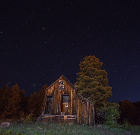 Spooky looking old wooden building at night.